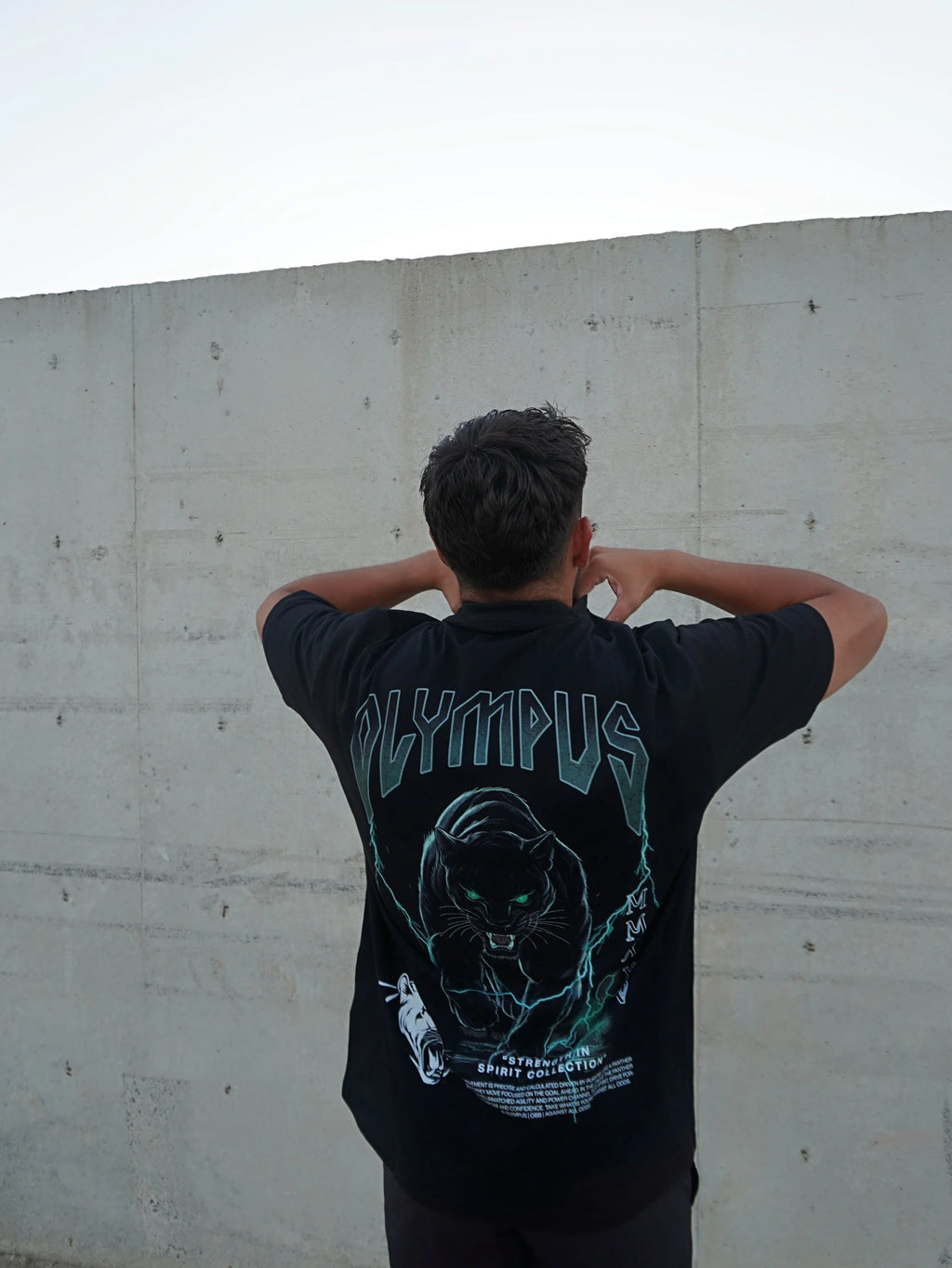 Black OLYMPUS Pantera heavyweight graphic tee back design worn outside by model 