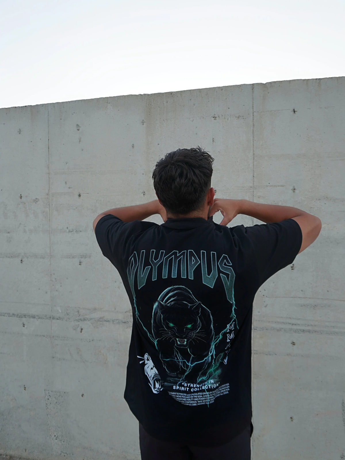 Black OLYMPUS Pantera heavyweight graphic tee back design worn outside by model 
